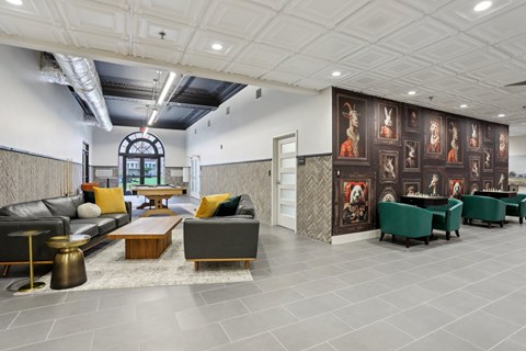A modern living room with a grey sofa, a coffee table, and a large painting on the wall.