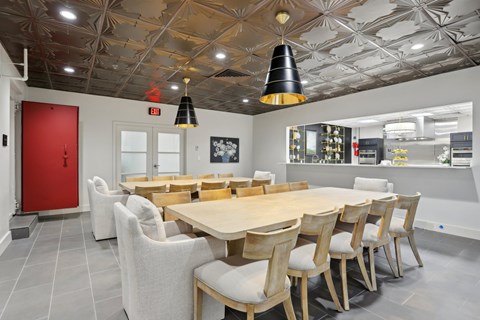 A dining room with a wooden table and chairs.