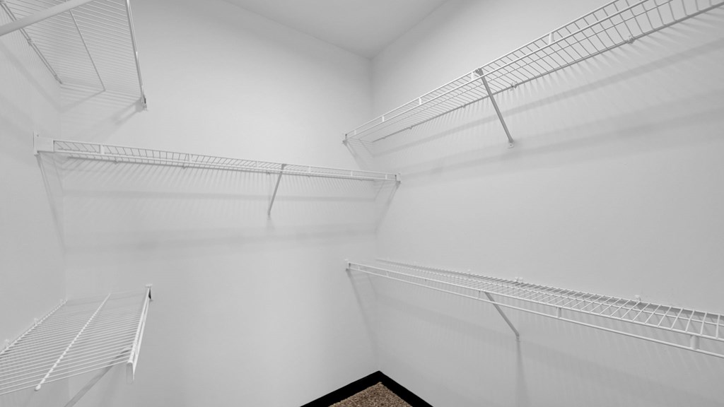 Empty white shelves in a room.