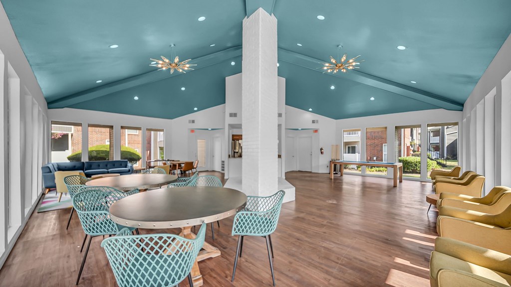 A large room with a round table and chairs.