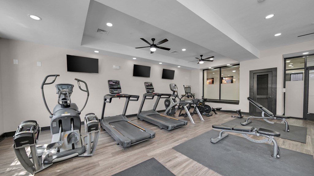 A spacious home gym with a variety of exercise equipment.