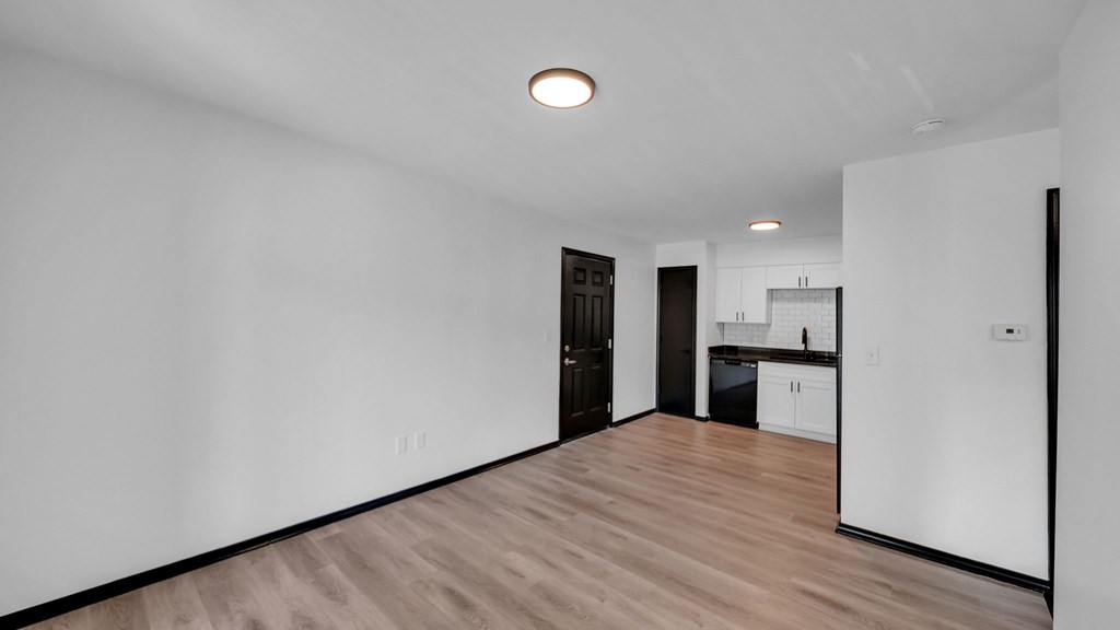 A room with a wooden floor and white walls. at The District Apartments, Tennessee