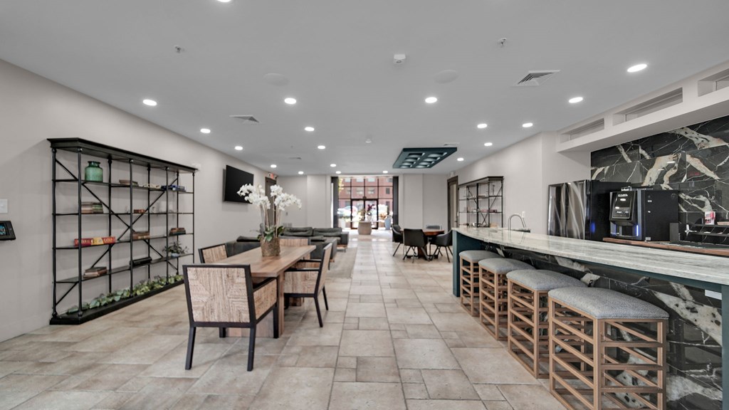 A modern kitchen with a dining table and chairs.