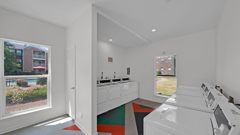 A white laundry room with a washer and dryer. at The Local Apartments, Memphis, TN, 38115