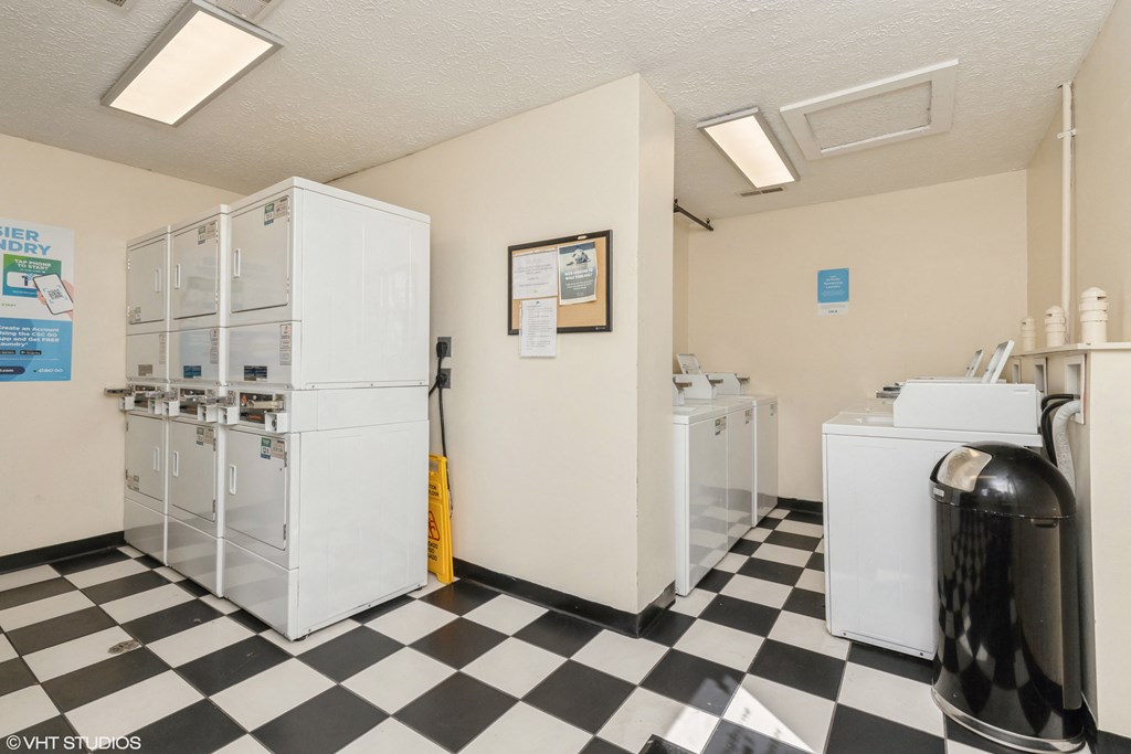 a laundry room with two refrigerators and a checkered floor at Springburne at Polaris Apartments, Ohio, 43235