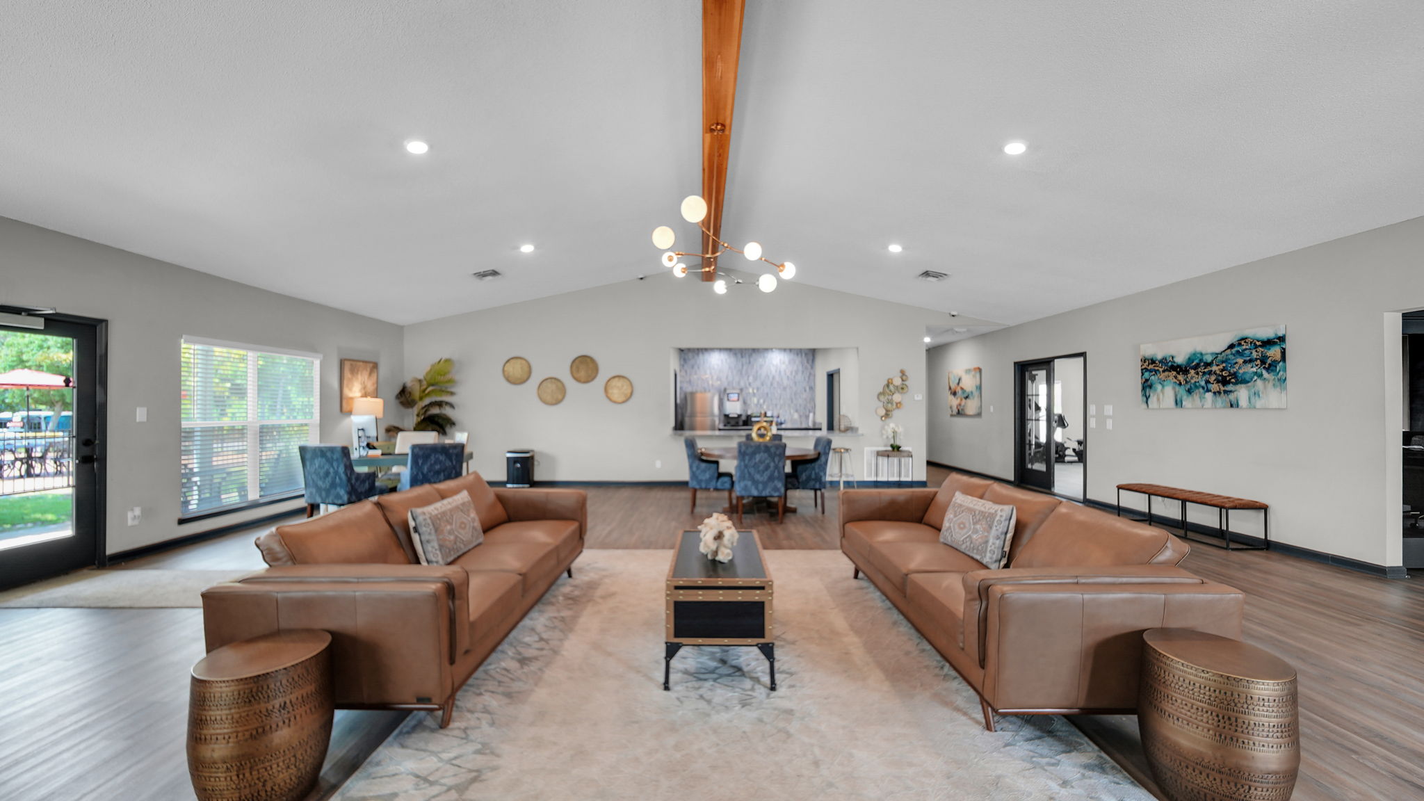 A living room with brown leather couches and a coffee table.