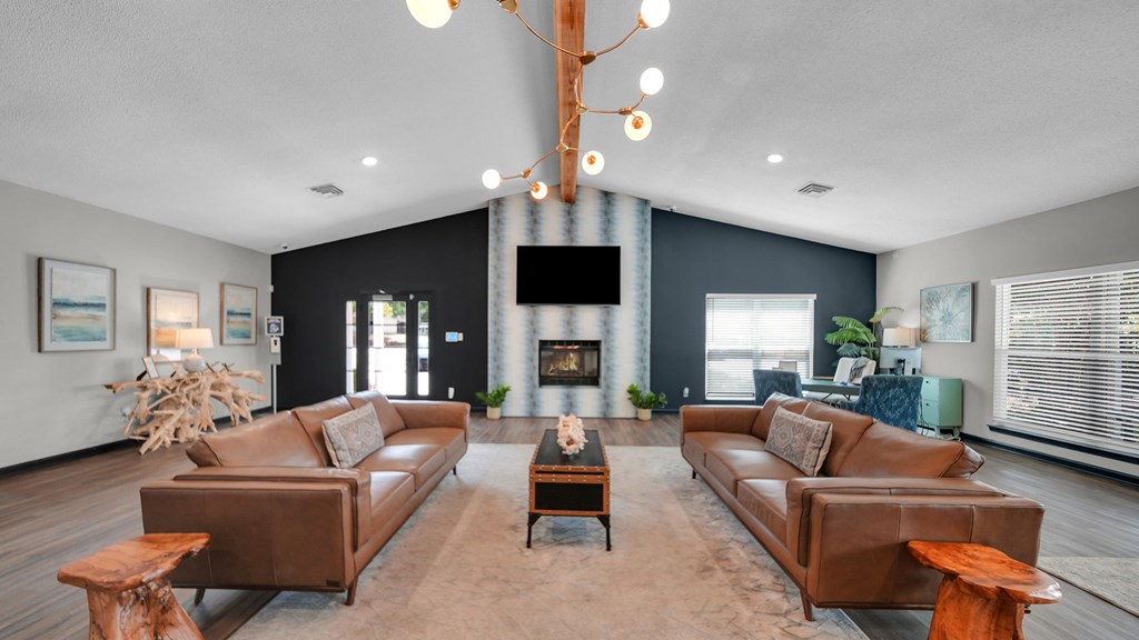 A living room with a fireplace and a large couch. at The District Apartments, Tennessee