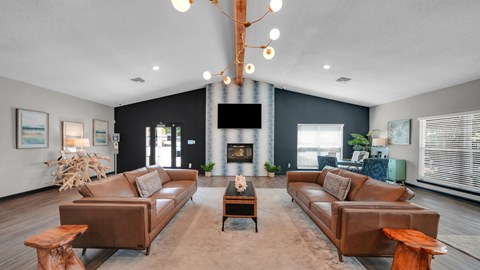 A living room with a fireplace and a large couch. at The District Apartments, Tennessee