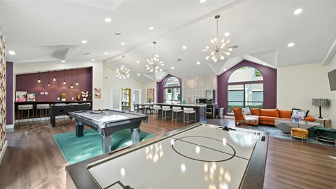 A room with a pool table and a billiard table.