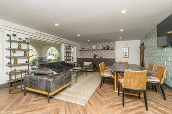 a living room with a couch and a table and a tv at Runaway Bay Apartments, Ohio