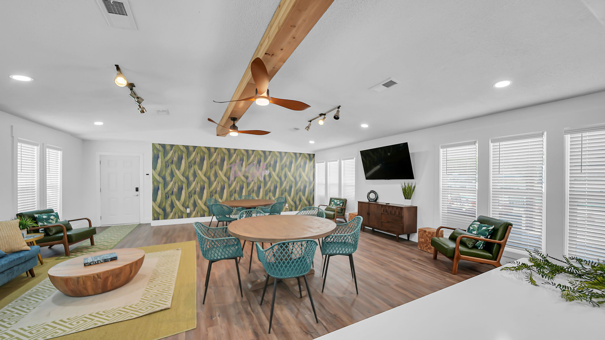 A living room with a wooden table and chairs.