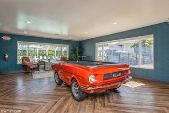 a pool table in a living room with a red car at Runaway Bay Apartments, Ohio, 43204