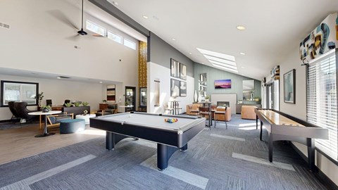 A spacious room with a pool table and comfortable seating.