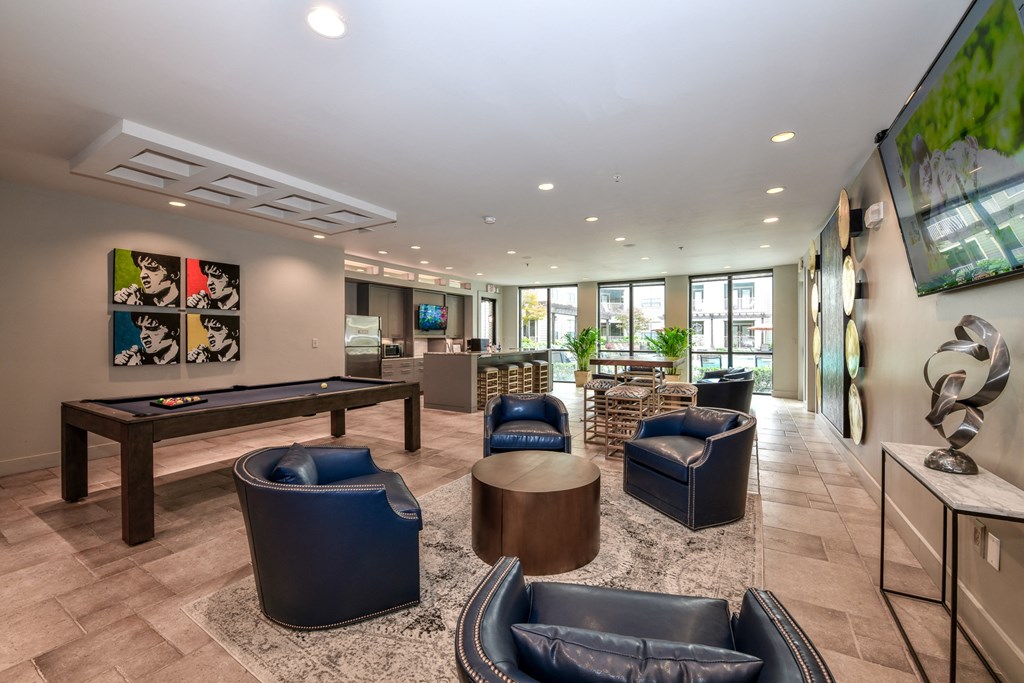 a resident clubhouse with a foosball table and a flat screen tv