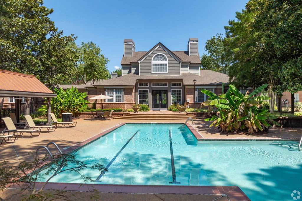 a swimming pool with a house in the background at The Grove Germantown Apartments, Germantown, 38138 ?