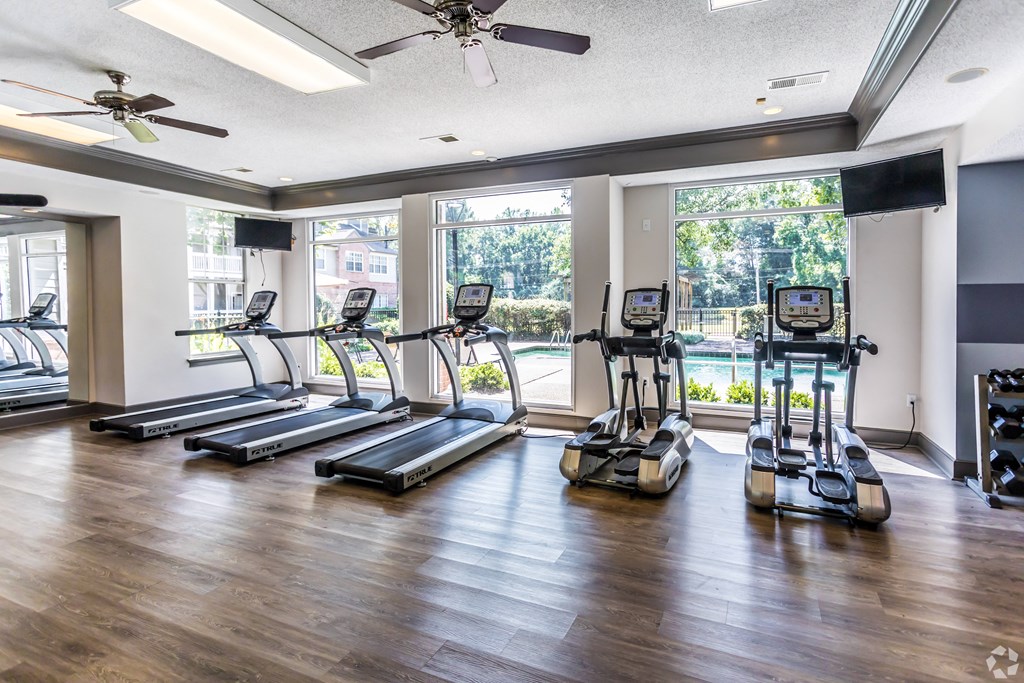the preserve at ballantyne commons fitness room with cardio equipment and windows at The Grove Germantown Apartments, Tennessee, 38138