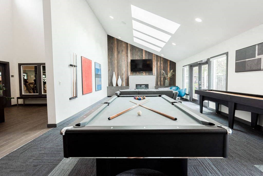 A pool table is in the middle of a room with a TV and a fireplace. A pool table is in the middle of a room with a TV and a fireplace at Altitude Apartment , Tacoma, 98444
