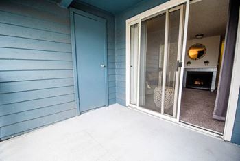A blue door is on the left and a glass door is on the right at Altitude Apartment , Washington