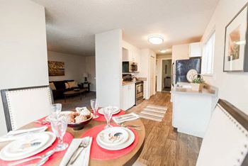 A dining table set for a meal with a red placemat at Altitude Apartment, Tacoma, WA, 98444