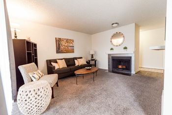 A living room with a fireplace and a couch at Altitude Apartment , Tacoma, Washington