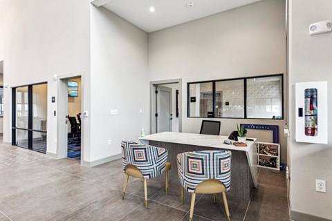 a kitchen with a counter top and three chairs