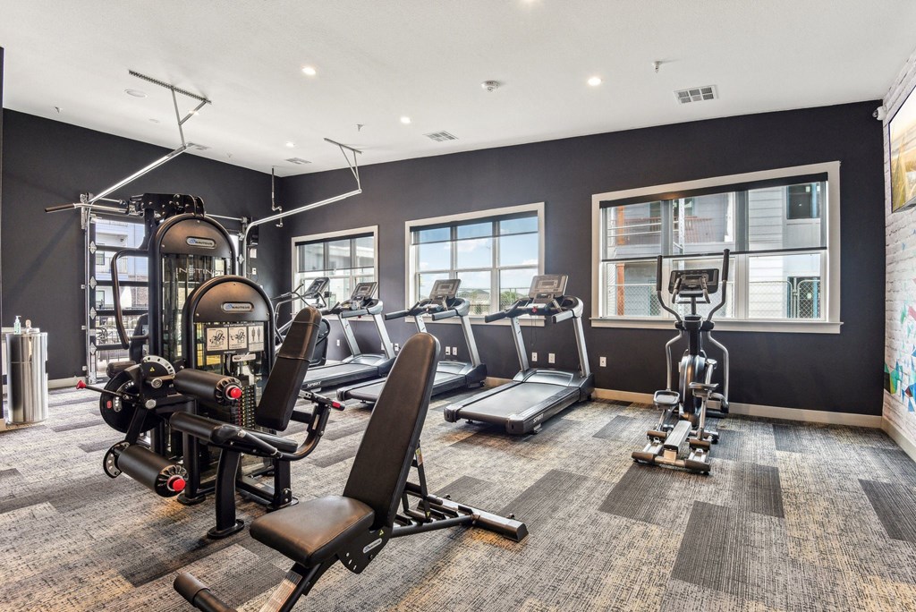 the gym with treadmills and weights at the belgard apartments at The Virginia, Seguin