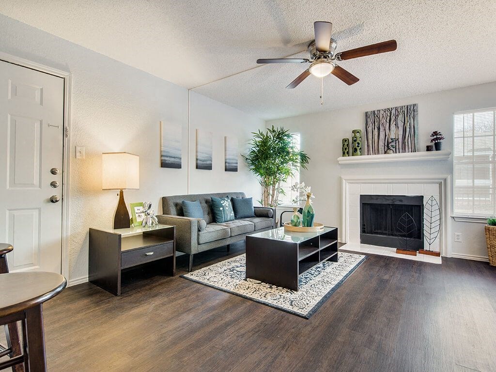Sophisticated Living Room Remodel With Fireplace at Wildwood Apartments, CLEAR Property Management, Texas, 78752
