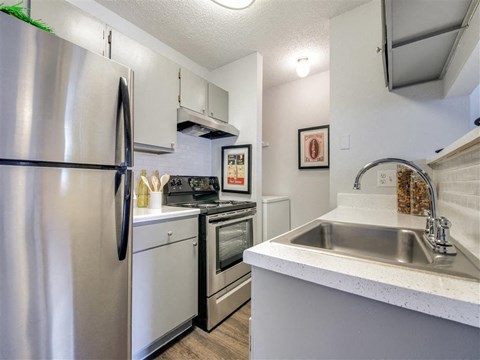 a kitchen with stainless steel appliances and a sink