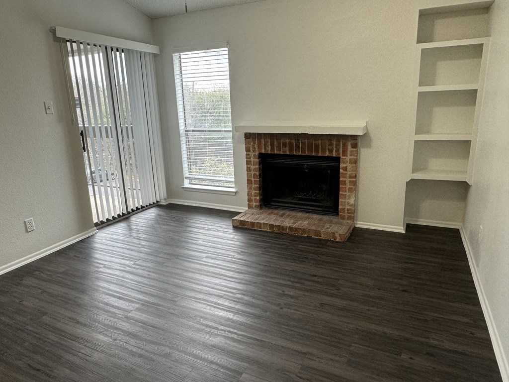 a living room with wood flooring and a fireplace  at Sunset Canyon, Texas, 78232