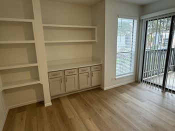 a dining room with built in shelving and a window  at Sunset Canyon, San Antonio, 78232