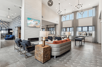 a living room with couches and chairs and a fireplace at The Virginia, Seguin, 78155