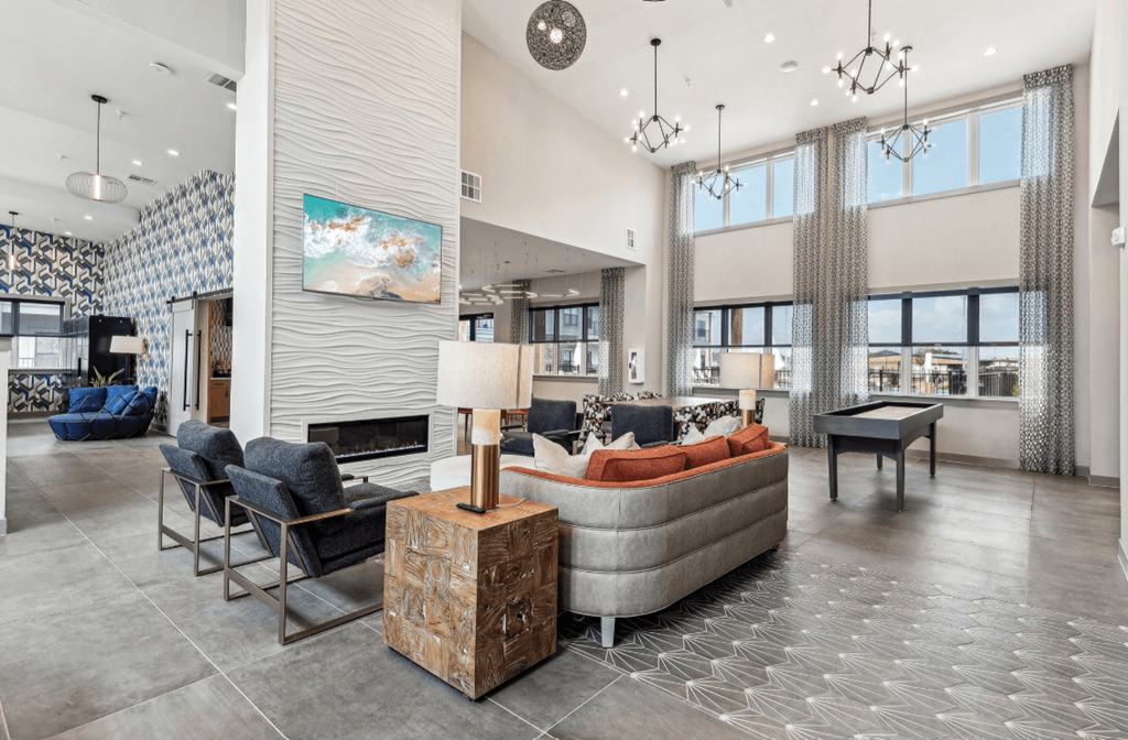 a living room with couches and chairs and a fireplace at The Virginia, Seguin, 78155