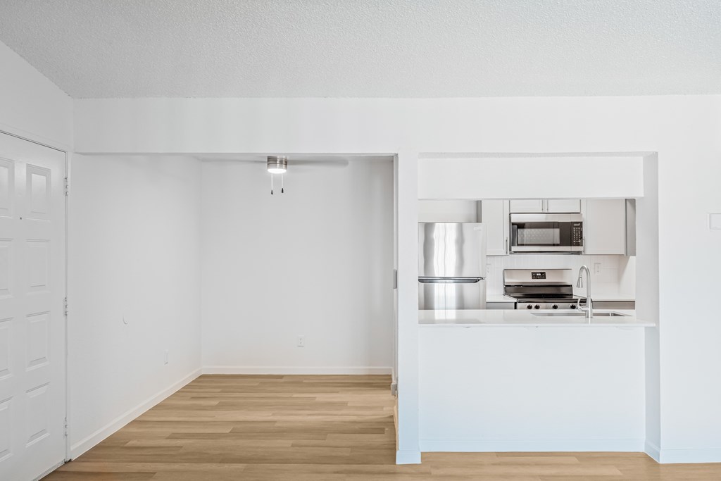 A kitchen with a stove top oven and a sink.