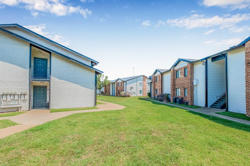 A row of houses with blue doors and windows.
