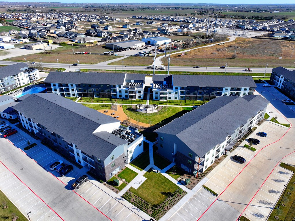 A large building with a parking lot in front of it at The Virginia, Seguin, TX