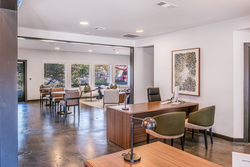 A conference room with a long table and chairs.