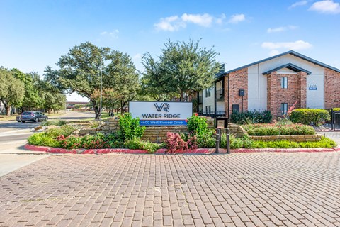 A sign in front of a building that says Water Ridge at Water Ridge Apartments , Irving, Texas
