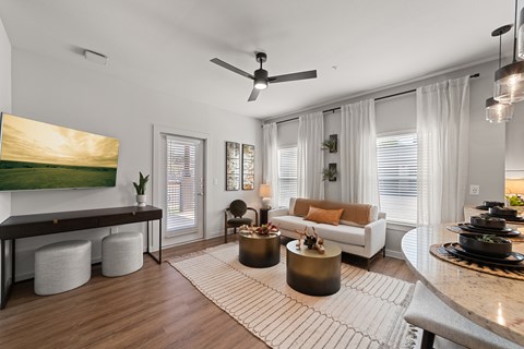 A modern living room with a large painting on the wall and a white sofa.