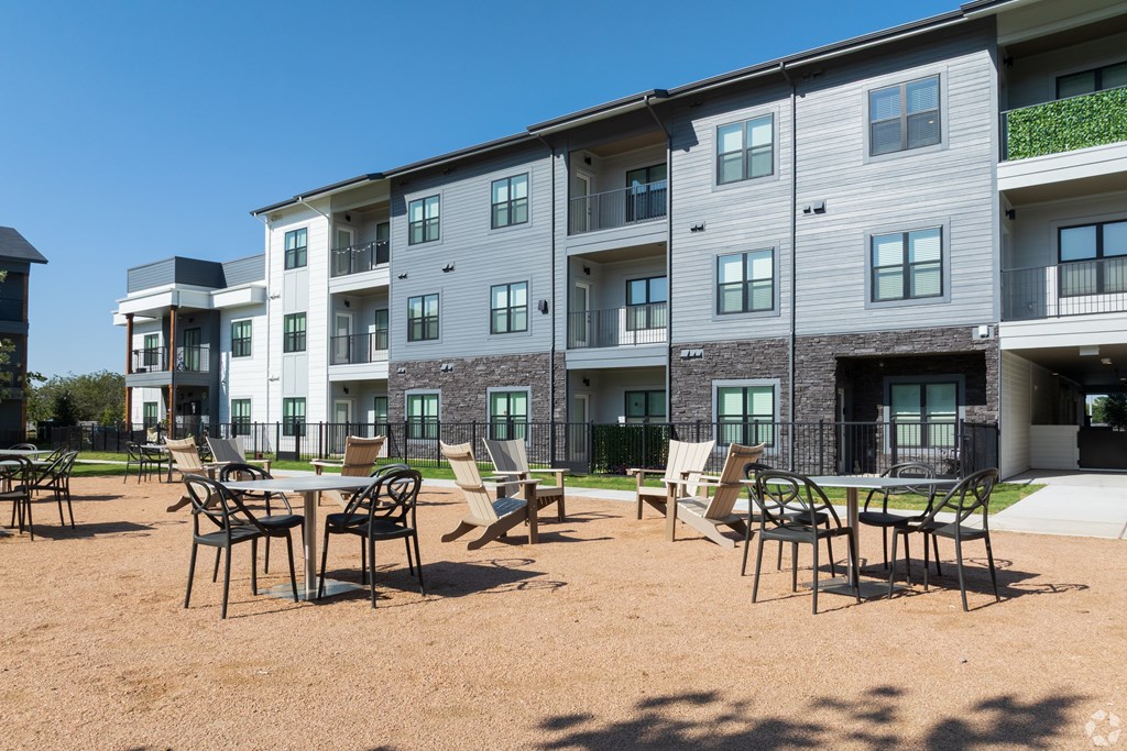 A sunny day at the outdoor seating area of a modern apartment complex.