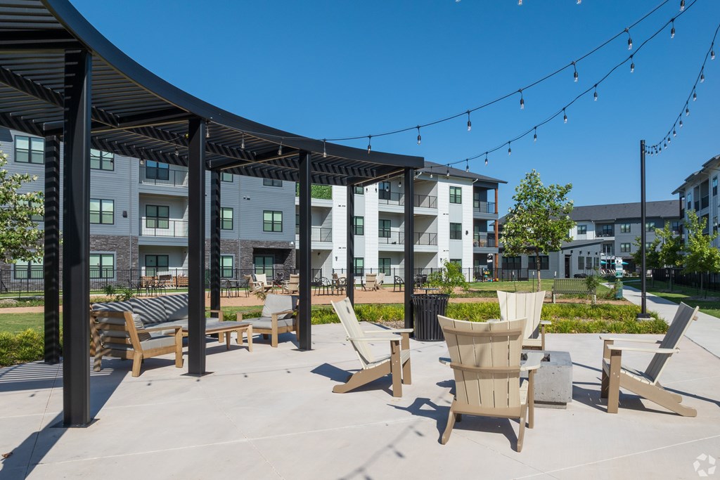 A patio area with chairs and a table.