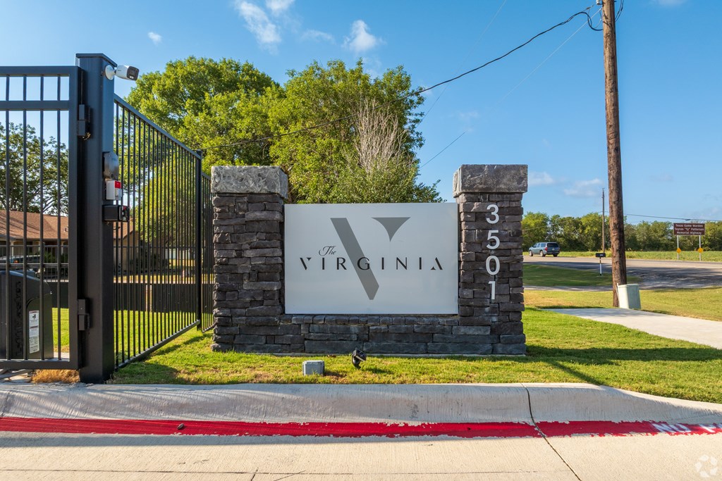 A sign that says Virginia is on a stone pillar.