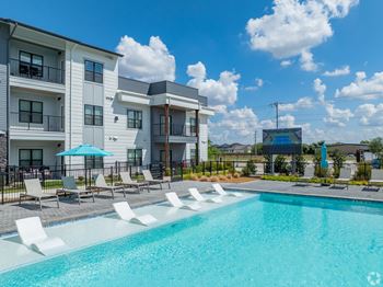 A swimming pool in front of apartment buildings.