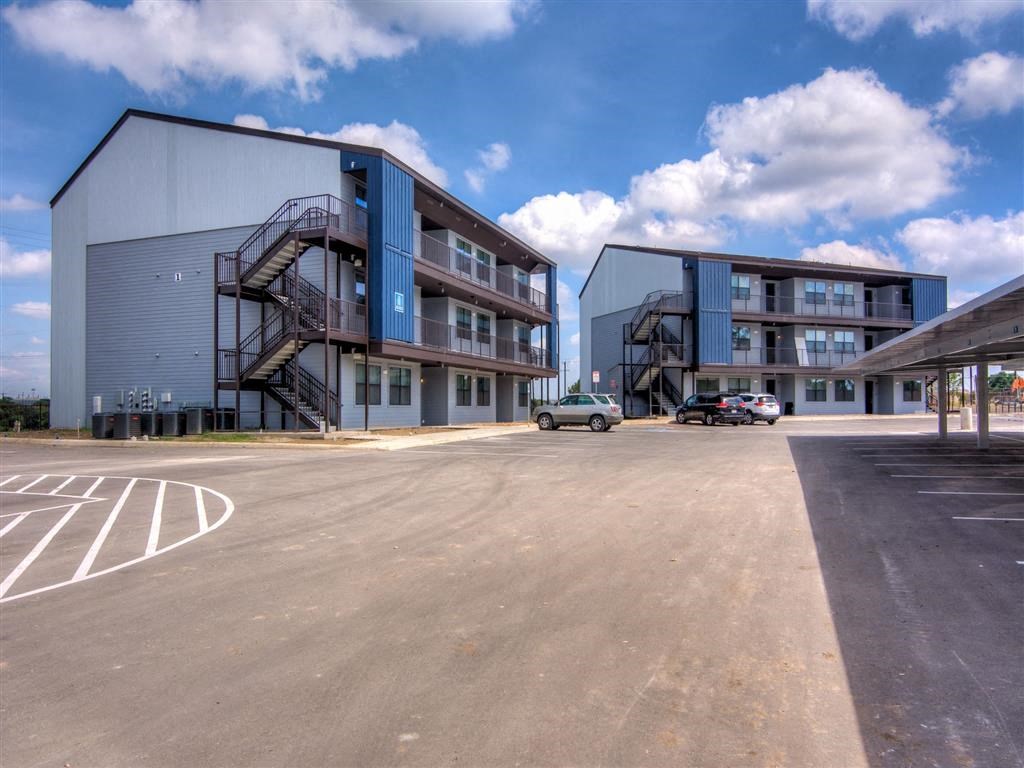 Building Exterior with Blue Skies at Aviator at Brooks Apartments, San Antonio