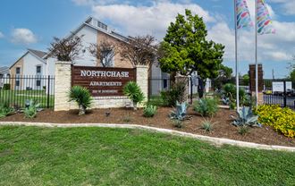 the entrance to northeast apartments sign in front of a fence