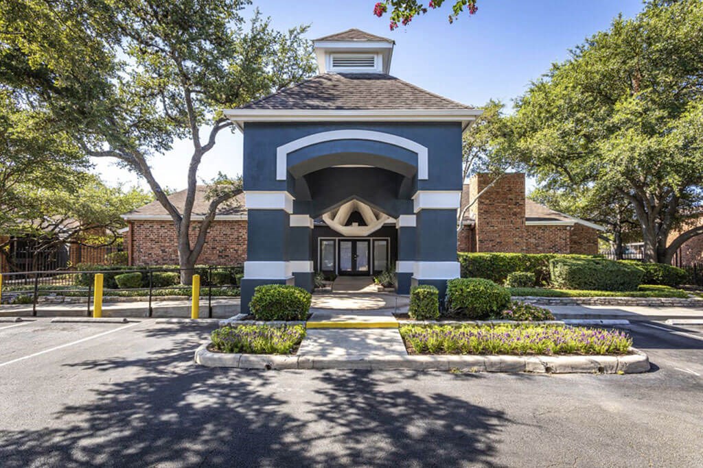a blue and white building with trees in the background  at Sunset Canyon, Texas