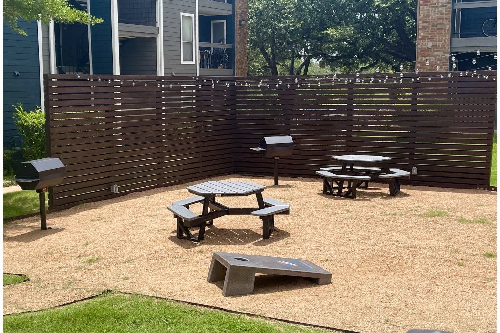 a patio with a picnic table and barbecue grill at Sunset Canyon, San Antonio, TX