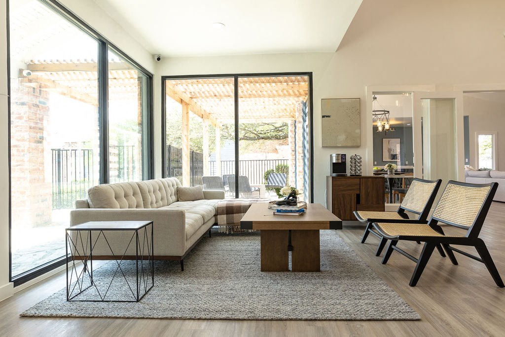 a living room with a white couch and a wooden coffee table in front of a sliding glass  at Sunset Canyon, San Antonio, TX, 78232