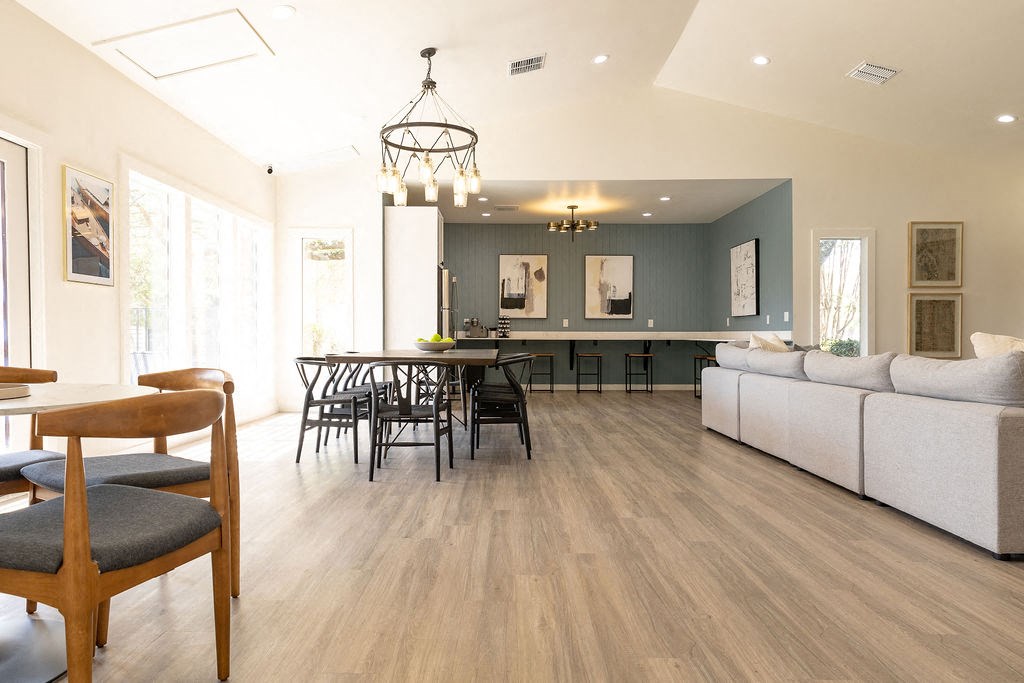 a living room and dining room with a hardwood floor and a vaulted ceiling  at Sunset Canyon, San Antonio, TX, 78232