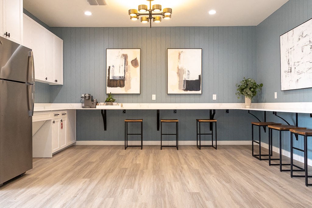 a kitchen with a long counter and stools  at Sunset Canyon, San Antonio, TX