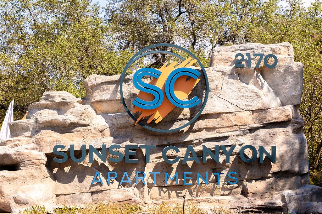 a sign for the sunseeker canyon apartments  at Sunset Canyon, Texas